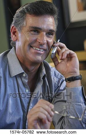 Close-up of a businessman talking on a mobile phone View Large Photo Image Stock Image - Close-up of a businessman talking on a mobile phone. Fotosearch