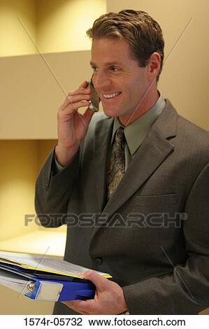 Stock Image - Close-up of a businessman using a mobile phone. Fotosearch