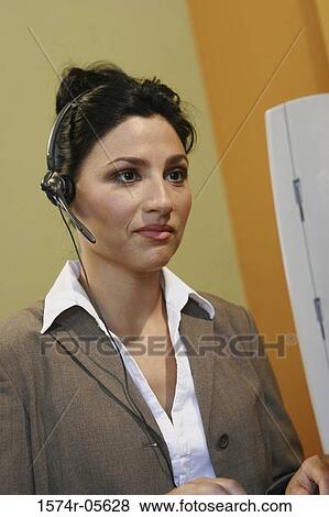 Close-up of a businesswoman wearing a headset View Large Photo Image Stock Photo - Close-up of a businesswoman wearing a headset. Fotosearch