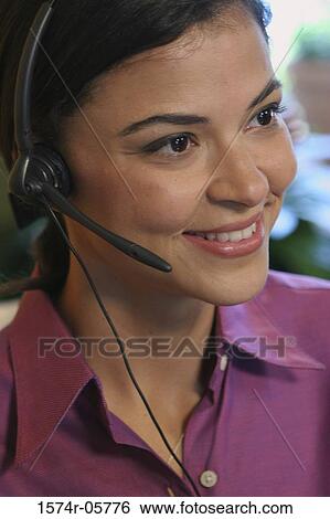 Stock Photograph - Close-up of a businesswoman wearing a headset. Fotosearch