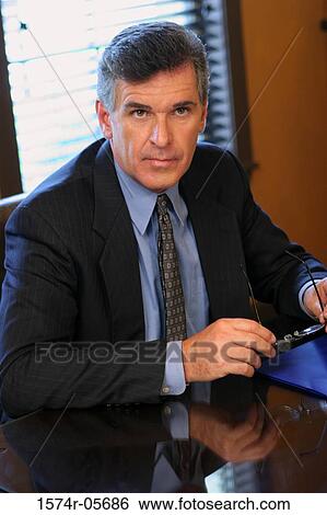 Portrait of a businessman in an office View Large Photo Image Stock Photograph - Portrait of a businessman in an office. Fotosearch