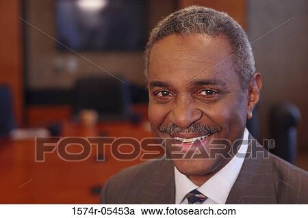 Stock Image - Portrait of a businessman smiling. Fotosearch