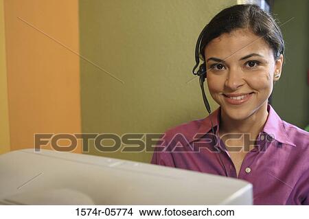 Picture - Portrait of a businesswoman wearing a headset. Fotosearch