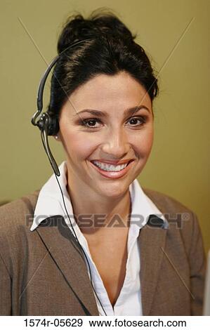 Stock Photo - Portrait of a businesswoman wearing a headset. Fotosearch