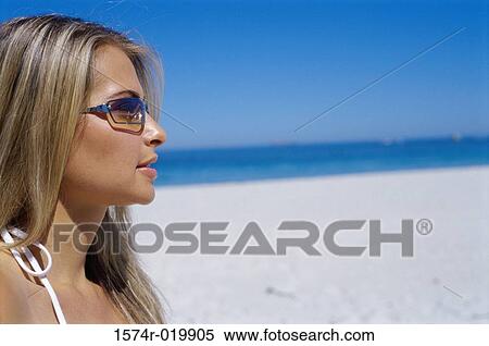 Close-up of a young woman on the beach View Large Photo Image Stock Photography - Close-up of a young woman on the beach. Fotosearch