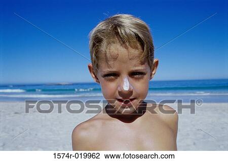 Portrait of a boy standing on the beach View Large Photo Image Stock Image - Portrait of a boy standing on the beach. Fotosearch