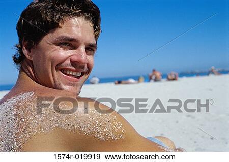Portrait of a young man smiling on the beach View Large Photo Image Stock Photo - Portrait of a young man smiling on the beach. Fotosearch