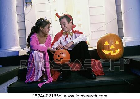 Stock Image - Boy and a girl dressed in Halloween costumes. Fotosearch