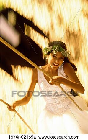Bride sitting on a swing View Large Photo Image Stock Image - Bride sitting on a swing. Fotosearch