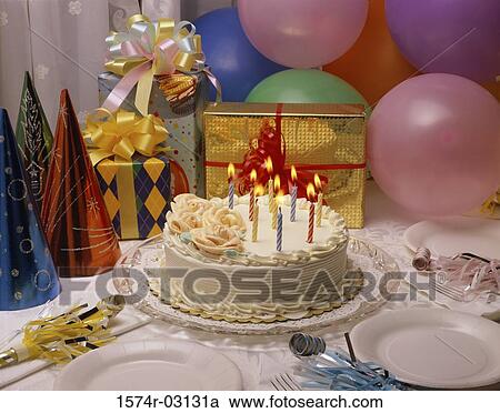 Stock Image - Close-up of a birthday cake and presents. Fotosearch