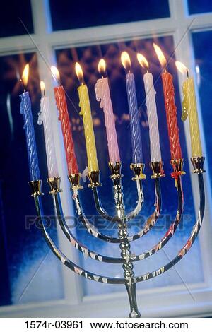 Stock Image - Close-up of lit candles on a menorah. Fotosearch