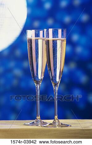 Close-up of two champagne flutes on a table View Large Photo Image Stock Image - Close-up of two champagne flutes on a table. Fotosearch