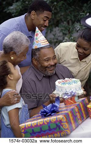 Stock Image - Family at a birthday party. Fotosearch