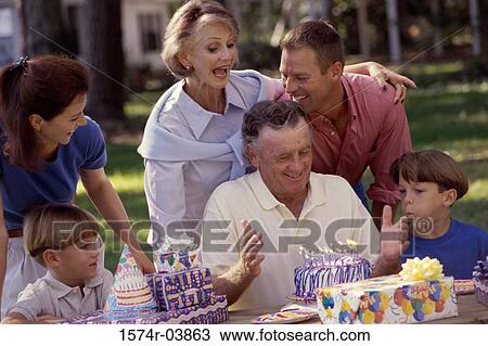 Stock Image - Family celebrating a birthday party. Fotosearch