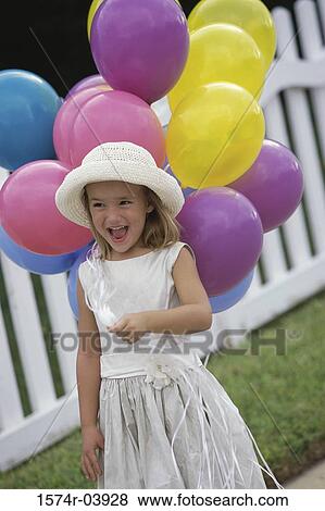 Stock Photo - Girl holding balloons. Fotosearch