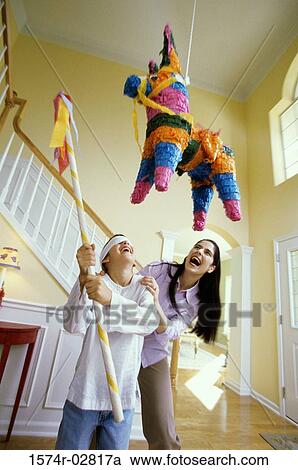 Girl wearing a blindfold hitting a pinata with a stick View Large Photo Image Stock Image - Girl wearing a blindfold hitting a pinata with a stick. Fotosearch