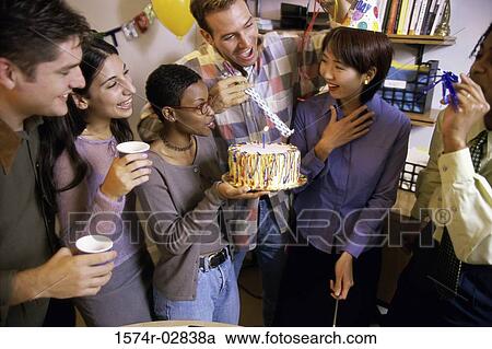 Group of business executives celebrating a birthday in the office View Large Photo Image Stock Image - Group of business executives celebrating a birthday in the office. Fotosearch