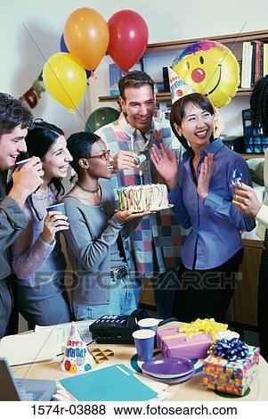 Group of business executives celebrating a birthday in the office View Large Photo Image Stock Photo - Group of business executives celebrating a birthday in the office. Fotosearch