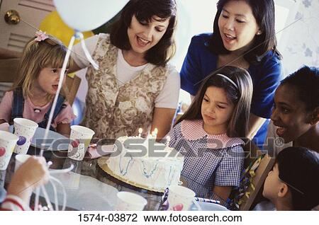 Stock Image - Group of children and their parents at a birthday party. Fotosearch