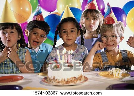Group of children in front of a birthday cake at a birthday party View Large Photo Image Stock Photo - Group of children in front of a birthday cake at a birthday party. Fotosearch