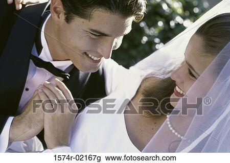 High angle view of a newlywed couple looking at each other View Large Photo Image Stock Image - High angle view of a newlywed couple looking at each other. Fotosearch