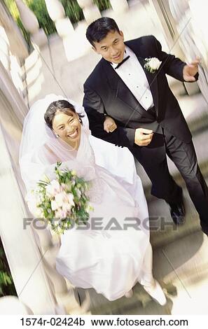 High angle view of a newlywed couple walking down stairs View Large Photo Image Stock Image - High angle view of a newlywed couple walking down stairs. Fotosearch