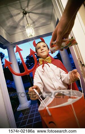 Low angle view of a boy dressed as the devil on Halloween View Large Photo Image Stock Image - Low angle view of a boy dressed as the devil on Halloween. Fotosearch