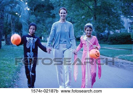 Mother with her son and daughter in Halloween costumes View Large Photo Image Stock Image - Mother with her son and daughter in Halloween costumes. Fotosearch