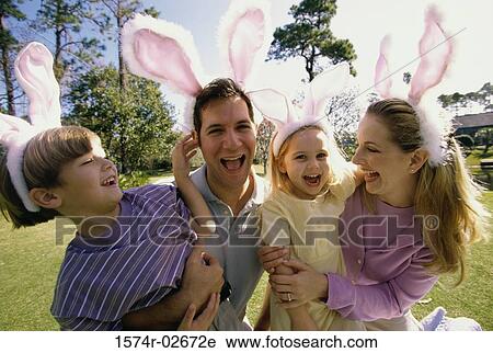 Parents and their son and daughter wearing pink bunny ears View Large Photo Image Stock Image - Parents and their son and daughter wearing pink bunny ears. Fotosearch