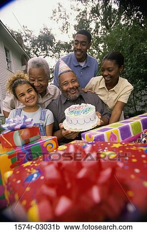 Stock Image - Portrait of a family at a birthday party. Fotosearch