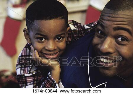 Picture - Portrait of a father and son smiling. Fotosearch