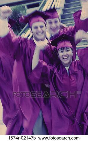 Stock Image - Portrait of a group of college students wearing graduation outfits. Fotosearch