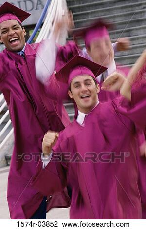 Stock Image - Portrait of a group of college students wearing graduation outfits. Fotosearch