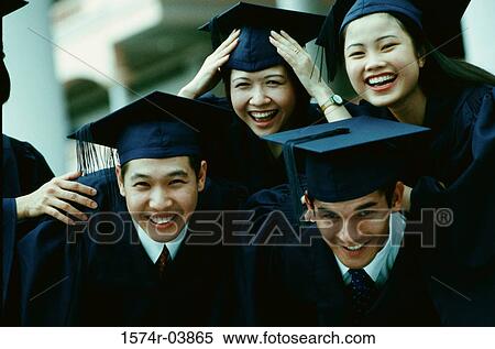Stock Photography - Portrait of a group of college students wearing graduation outfits. Fotosearch