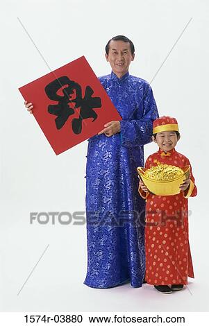 Portrait of a mid adult man holding a poster and a pot of gold with his son View Large Photo Image Stock Image - Portrait of a mid adult man holding a poster and a pot of gold with his son. Fotosearch