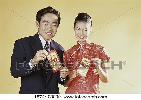 Portrait of a young couple holding greeting cards View Large Photo Image Stock Photo - Portrait of a young couple holding greeting cards. Fotosearch