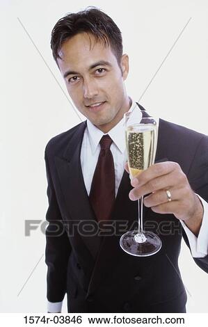 Portrait of a young man holding a glass of champagne View Large Photo Image Stock Photograph - Portrait of a young man holding a glass of champagne. Fotosearch