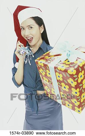 Portrait of a young woman holding a gift View Large Photo Image Stock Image - Portrait of a young woman holding a gift. Fotosearch