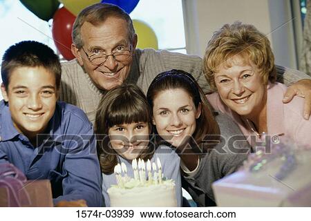 Portrait of grandparents and their grandchildren in front of a cake View Large Photo Image Stock Photo - Portrait of grandparents and their grandchildren in front of a cake. Fotosearch