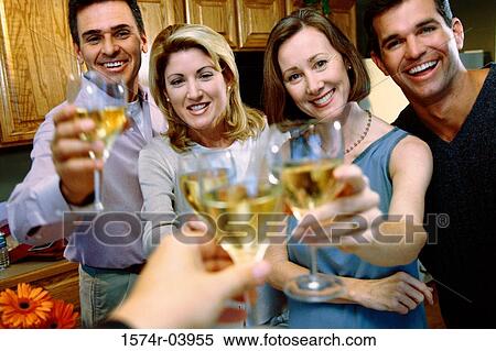 Stock Photography - Portrait of two mid adult couples toasting at a party. Fotosearch