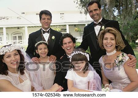Stock Image - Portrait of wedding guests with a newlywed couple. Fotosearch