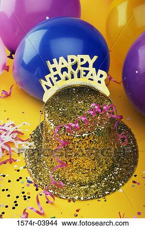 Picture - Sequined hat with a Happy New Year sign and streamers with balloons. Fotosearch