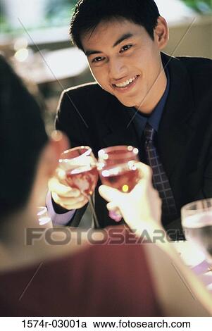 Young couple toasting with wineglasses View Large Photo Image Stock Image - Young couple toasting with wineglasses. Fotosearch
