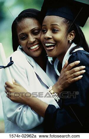 Young female graduate hugging her mother View Large Photo Image Stock Image - Young female graduate hugging her mother. Fotosearch