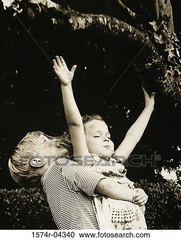 Boy carrying a girl on a lawn View Large Photo Image Stock Image - Boy carrying a girl on a lawn. Fotosearch