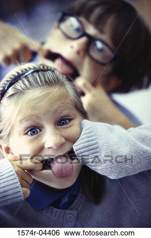 Close-up of a boy and a girl making faces View Large Photo Image Stock Photograph - Close-up of a boy and a girl making faces. Fotosearch