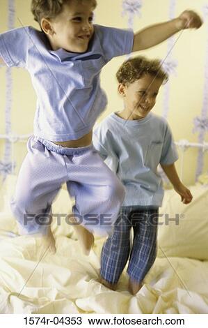 Close-up of two boys playing on a bed View Large Photo Image Stock Image - Close-up of two boys playing on a bed. Fotosearch