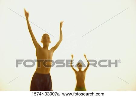Front view of two boys standing with their arms raised View Large Photo Image Stock Image - Front view of two boys standing with their arms raised. Fotosearch