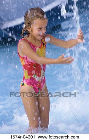 Girl playing in a swimming pool View Large Photo Image Stock Image - Girl playing in a swimming pool. Fotosearch