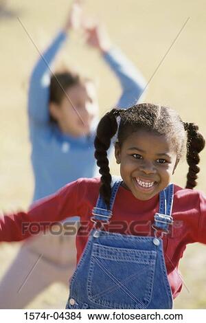 Girls playing on a lawn View Large Photo Image Picture - Girls playing on a lawn. Fotosearch